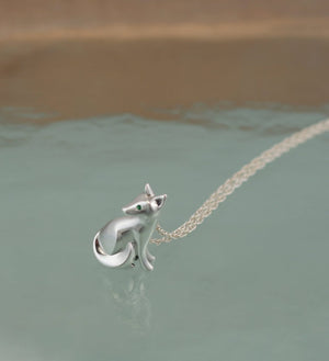 sitting kit fox pendant ,   silver.  pick finish and eye color