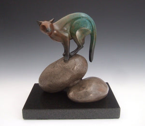 puma on rocks sculpture with turquois/rust patina