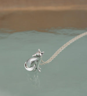 silver sitting kit fox pendant, with gemstone eyes