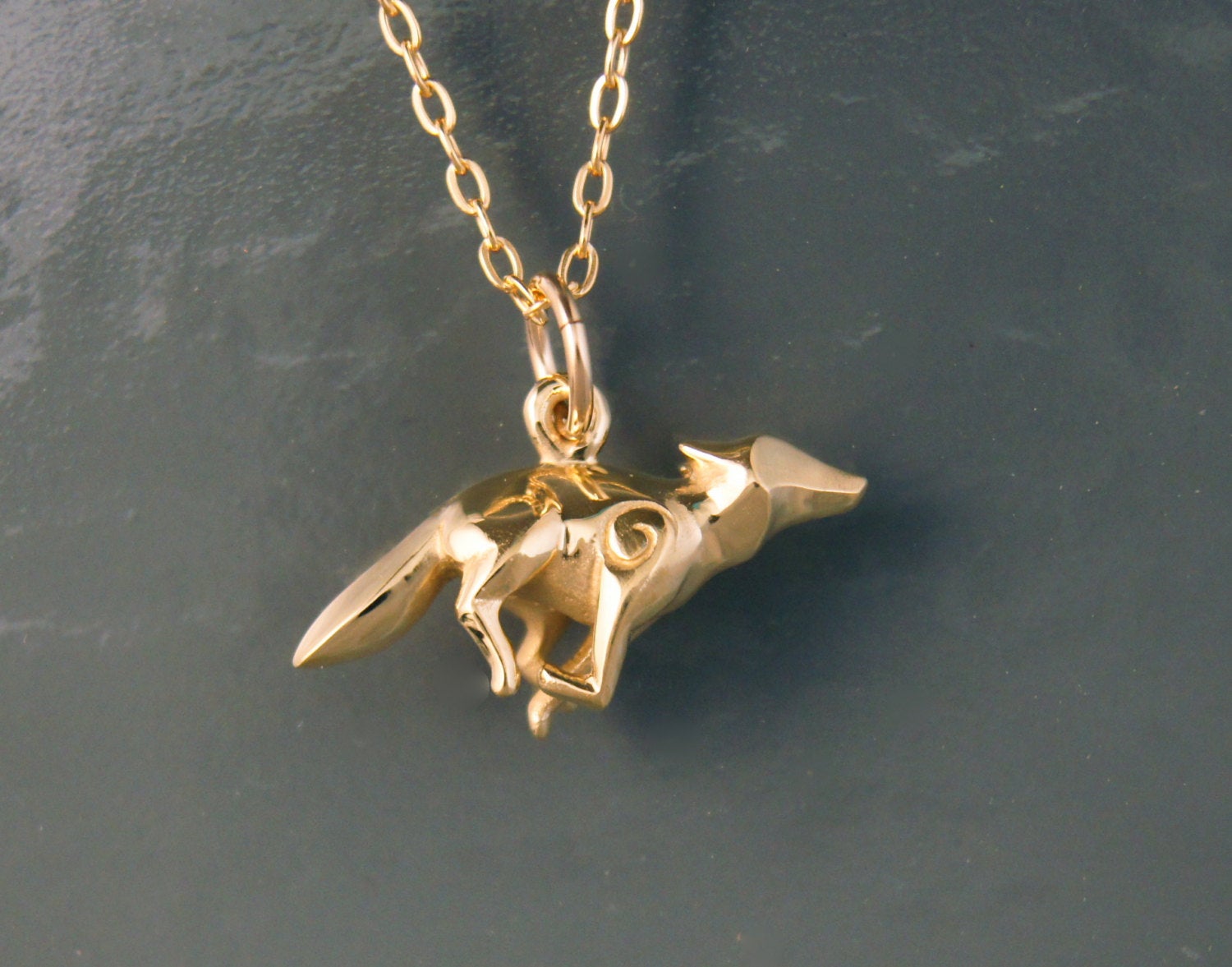 bronze running coyote pendant