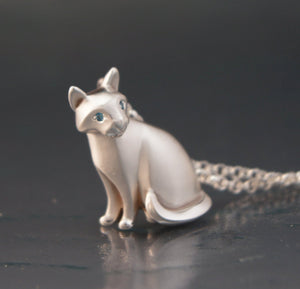 silver sitting cat pendant, with diamond eyes